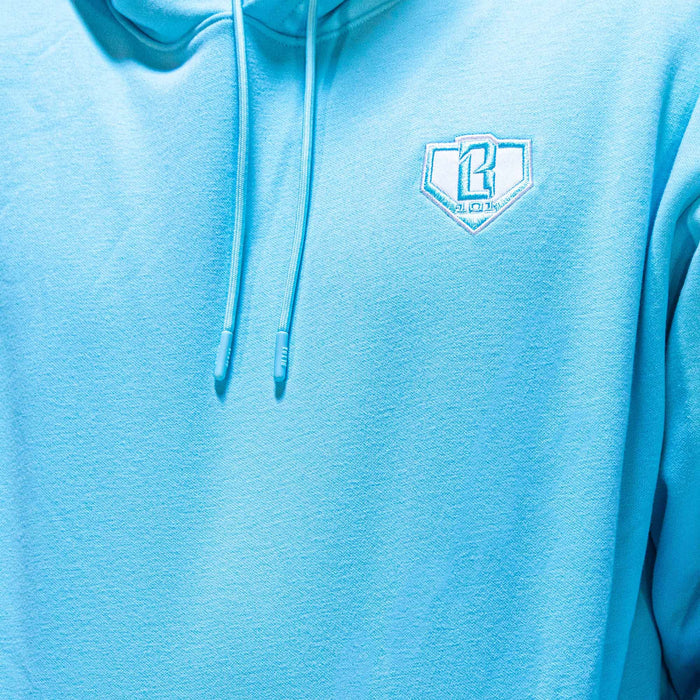 Adult model wearing blue Baseline Light Blue hoodie
