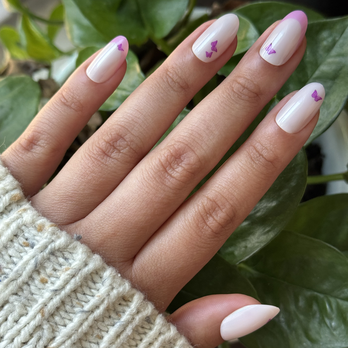 Butterfly Mixed French - Press-On | Medium | Oval with neutral base, pink-purple tips, and small butterfly accents for easy mani