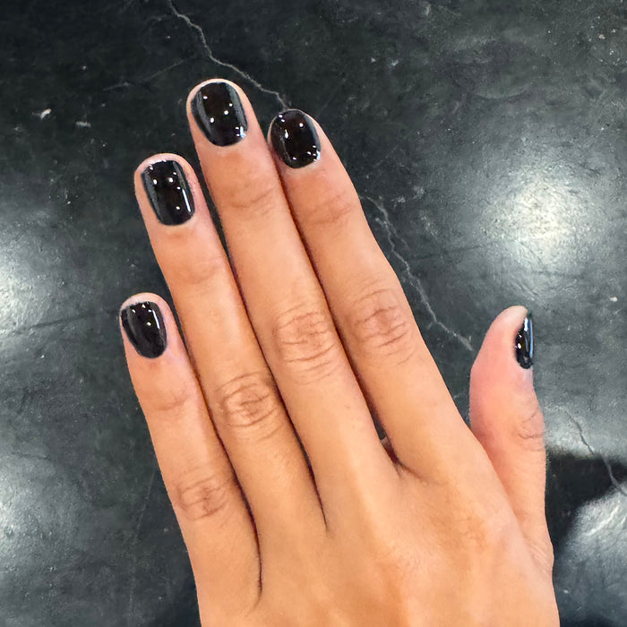 E+M - Gel shown on hand with glossy deep black nails for a sleek and long-lasting manicure by Olive and June