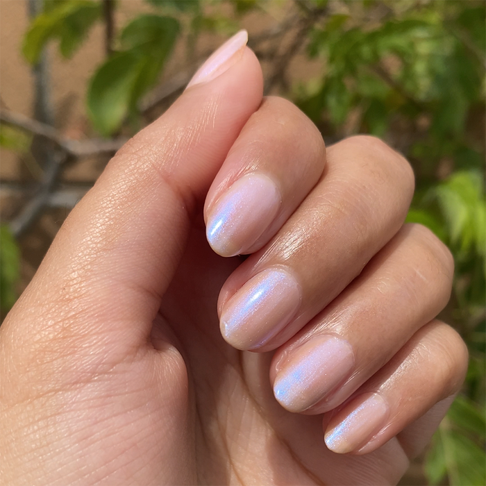 Glazed Donut Set manicure showing soft pink nails with subtle blue iridescent shimmer and glossy finish by Olive and June