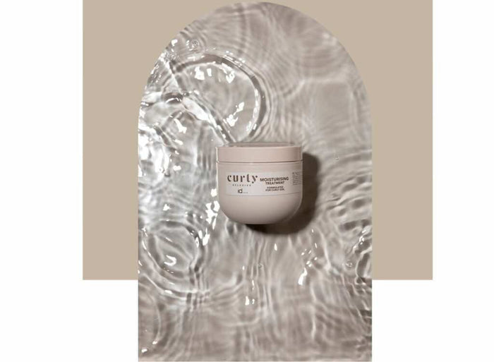 IdHAIR Curly Xclusive moisturizing hair treatment for soft, nourished curls with aloe vera and coconut oil in 200ml container
