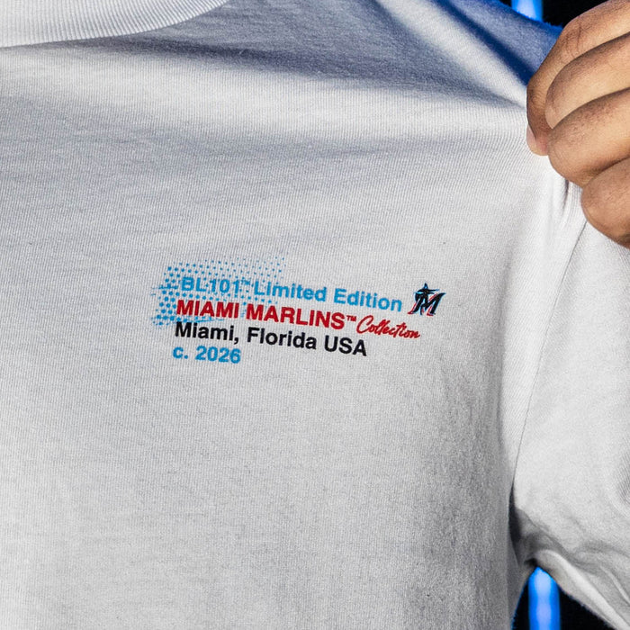 Adult model wearing white graphic tee with "Miami Marlins Drip" design
