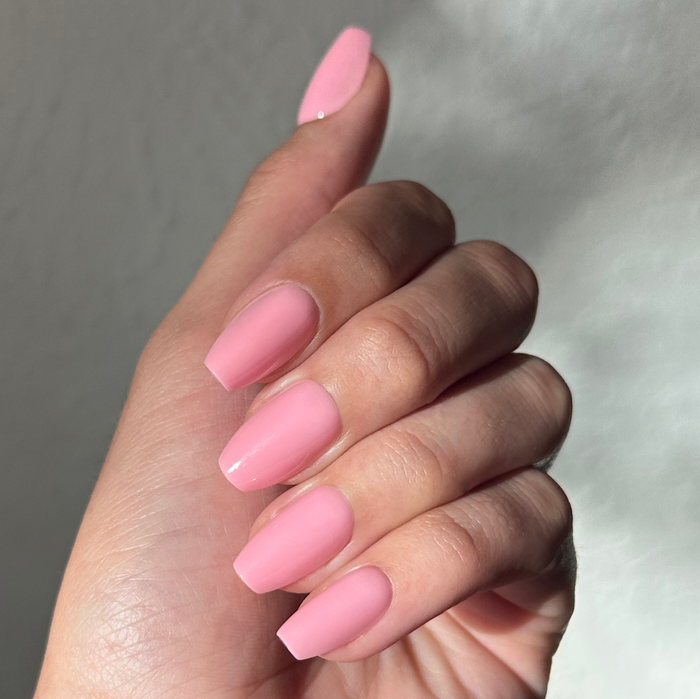 O&J Pink - Press-On | Medium | Coffin false nails in soft cotton candy pink shown on hand with natural light reflection