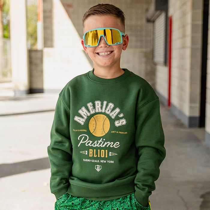 Child wearing a forest green America's Pastime crewneck sweatshirt.