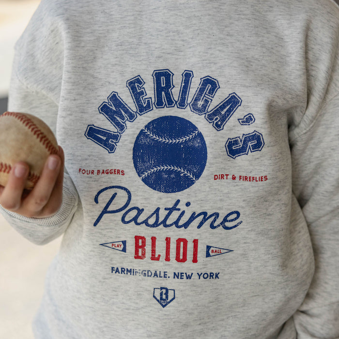 Close up of gray heather America's Pastime crewneck sweatshirt graphic with a baseball held at the side
