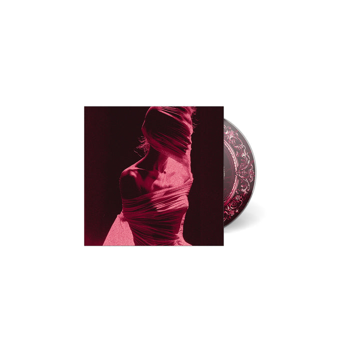 A partially visible music CD behind its cover, which displays a stylized figure wrapped in translucent fabric with dramatic red and pink lighting on a dark background. Product by Arankai.