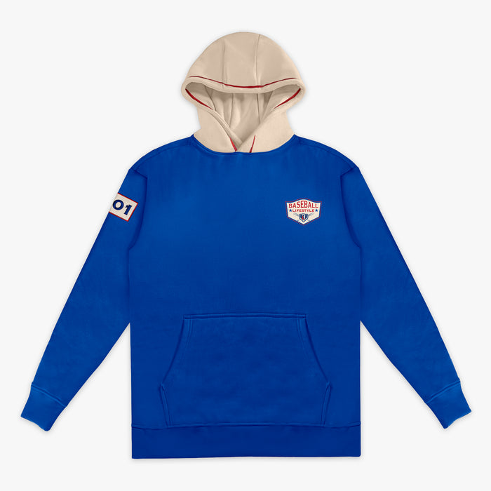 Royal blue hoodie with a cream hood, showing the Baseball Lifestyle shield chest logo, sleeve patch, on a white background.