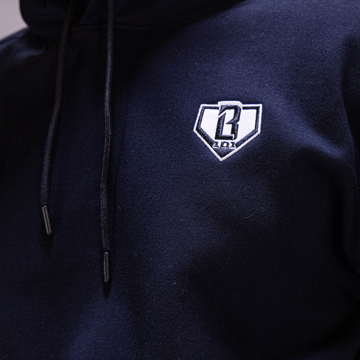 Adult model wearing black Baseline hoodie
