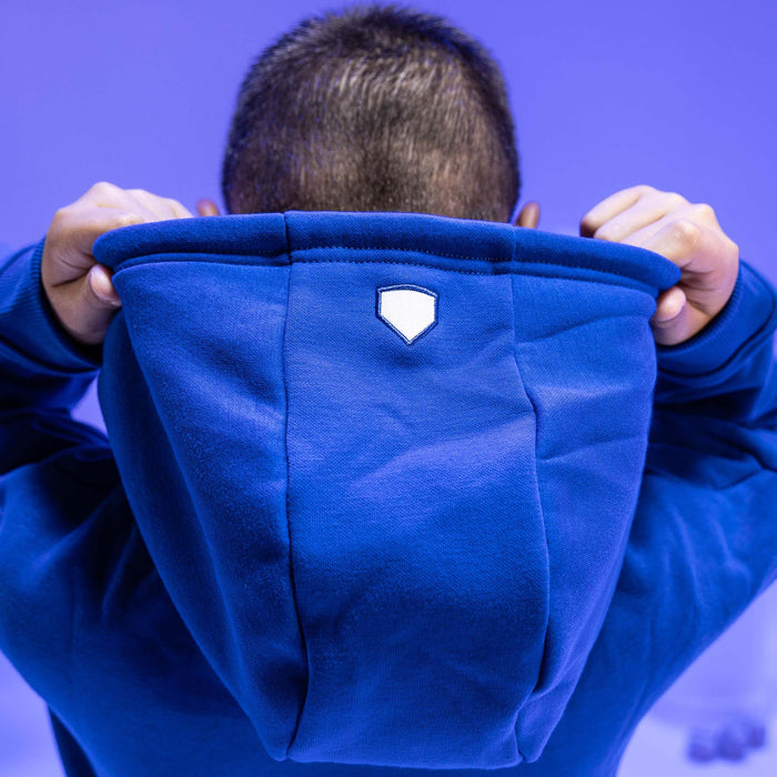 Adult model wearing blue Baseline hoodie