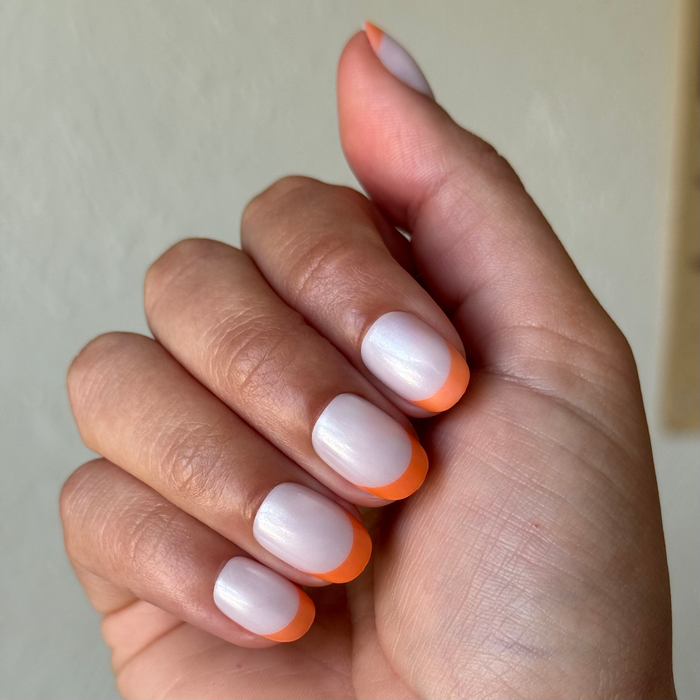Bounce Back Chrome French - Press-On | Extra Short | Round nails with shiny orange tangerine chrome tips for easy at-home mani