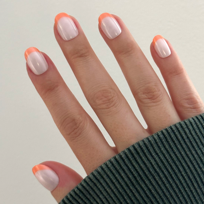 Bounce Back Chrome French - Press-On | Extra Short | Round nails with bright orange tangerine tips for an easy at-home manicure