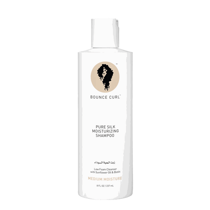 Bounce Curl Pure Silk moisturizing shampoo bottle with natural ingredients and citrus scent on white background