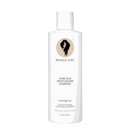 Bounce Curl Pure Silk moisturizing shampoo bottle with natural ingredients and citrus scent on white background