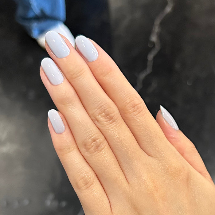 BP - Gel shown on hand with nails painted in a smooth icy light blue shade for a polished gel manicure by Olive and June