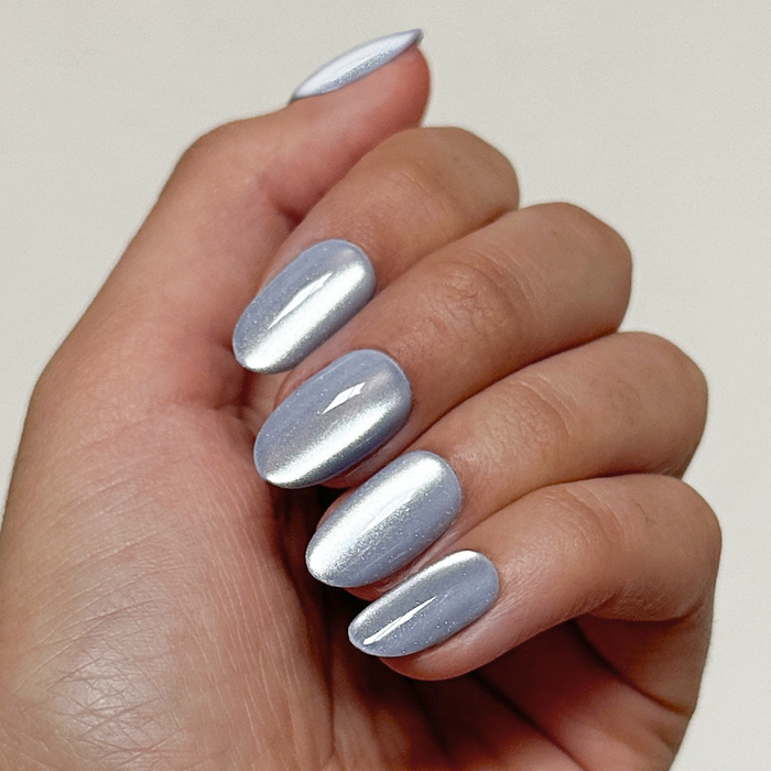 BP Velvet | Medium | Oval - Tab Press-On nails in medium oval shape with shiny icy blue metallic finish on hand