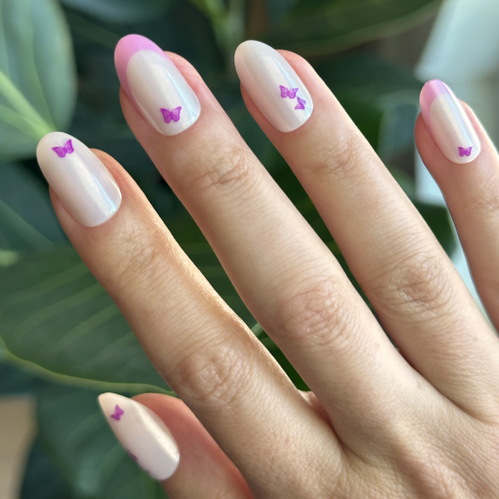 Butterfly Mixed French - Press-On | Medium | Oval with neutral shimmer, soft pink tips, and delicate purple butterfly accents for easy mani