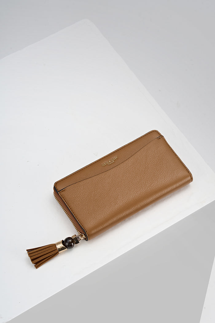 Overhead view of the front of Capriana Tan faux leather Large Purse with mini Thames Tassel detail on the zip