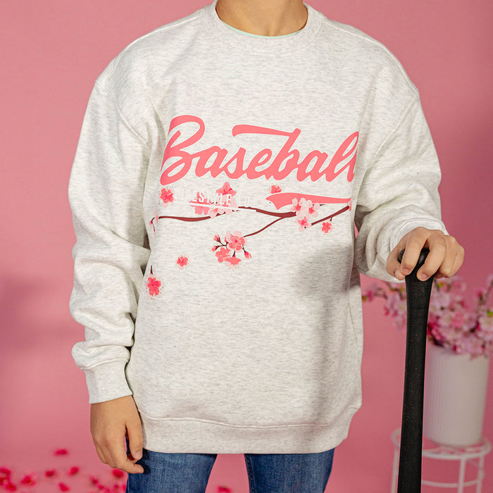 Youth model wearing gray youth crewneck with “Cherry Blossoms Established” design