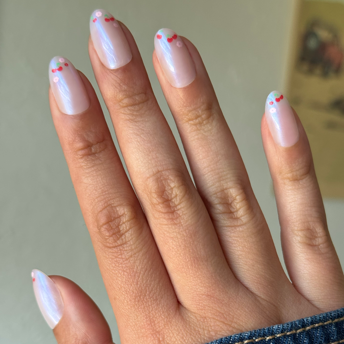 Cherry Floral Chrome French - Press-On | Medium | Oval with shimmery chrome base and delicate cherry tip design on natural hand