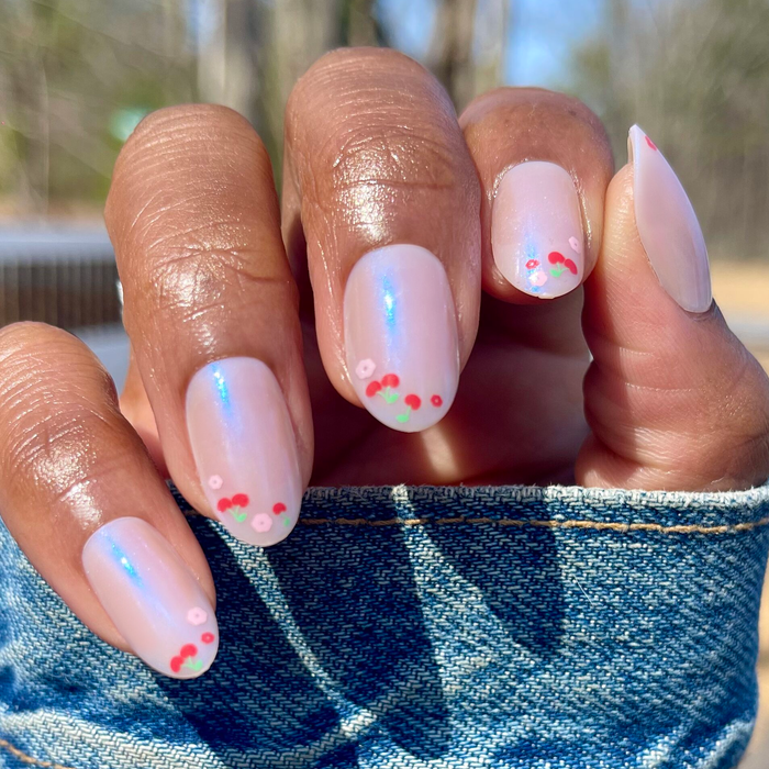 Cherry Floral Chrome French - Press-On | Medium | Oval with shimmery chrome base and delicate cherry tip nail art on natural hand