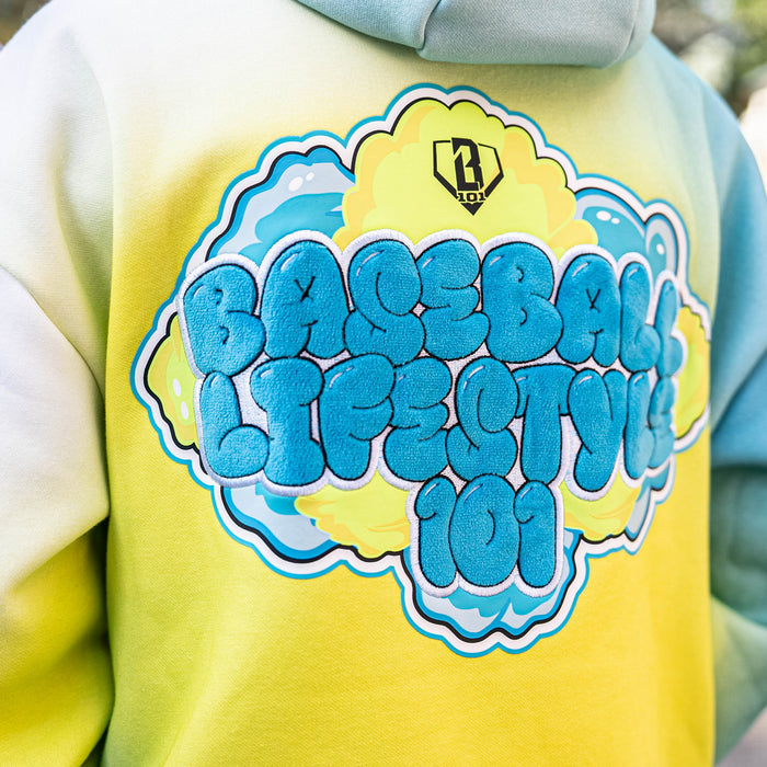 Yellow hoodie with blue BL101 logo on a blurred background