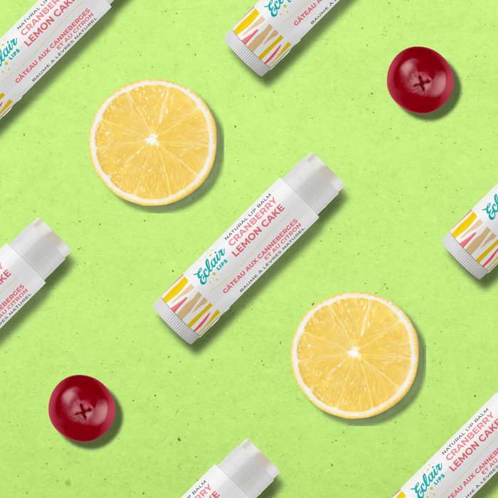 Flatlay of Cranberry Lemon Cake lip balm with lemon slices and cranberries