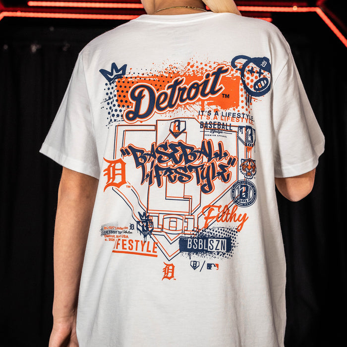 Adult model wearing white graphic tee with "Detroit Tigers Drip" design