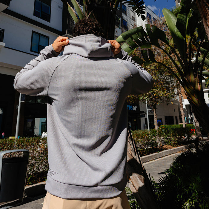 Adult model wearing gray Diamond Tech Jacquard hoodie