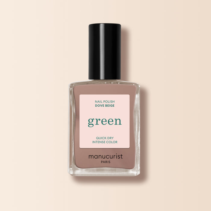 A bottle of Manucurist nail polish in the shade Dove Beige, shown in a clear rectangular bottle with a black cap and pastel beige label, set against a light beige background.