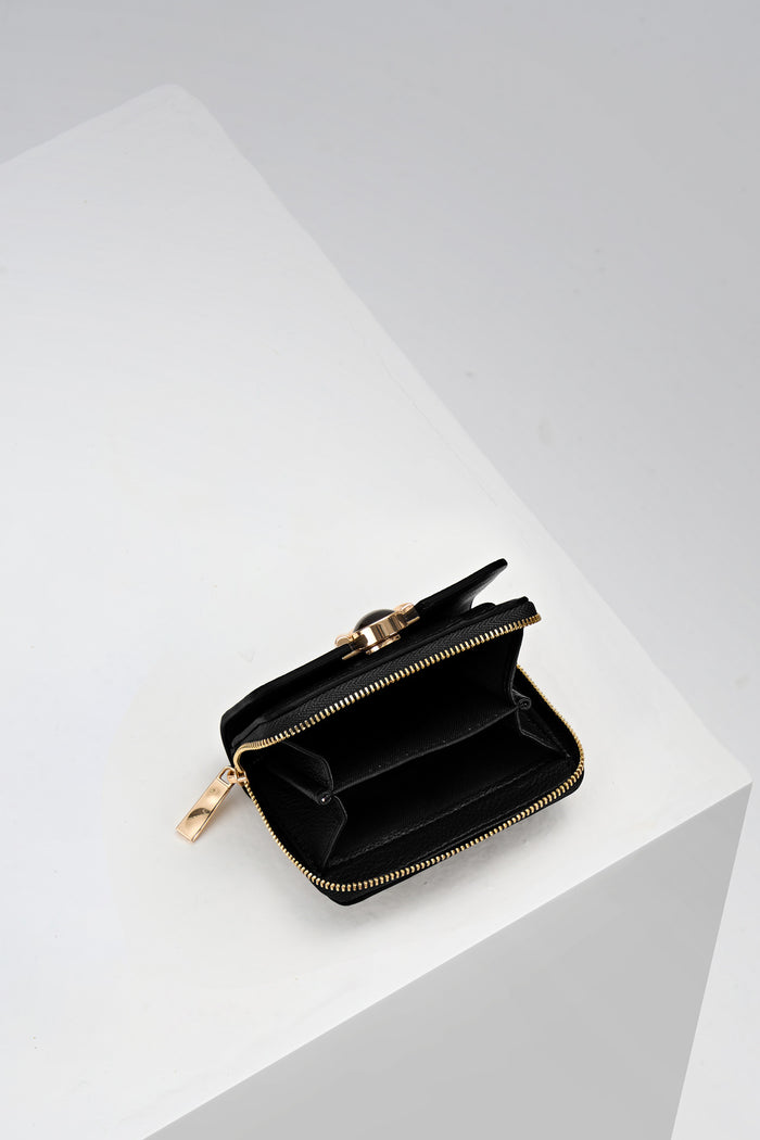 Inside of Erin Black Small Faux Leather Purse by Luella Grey which is unzipped showing the coin slots inside