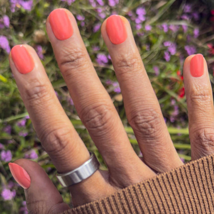 Frolic | Extra Short | Round - Tab Press-On nails in bright orangey coral for easy at-home manicure application