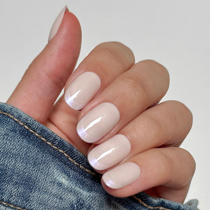 Glazed French | Short | Round - Tab Press-On nails with shimmering chrome French tips in short rounded shape on hand