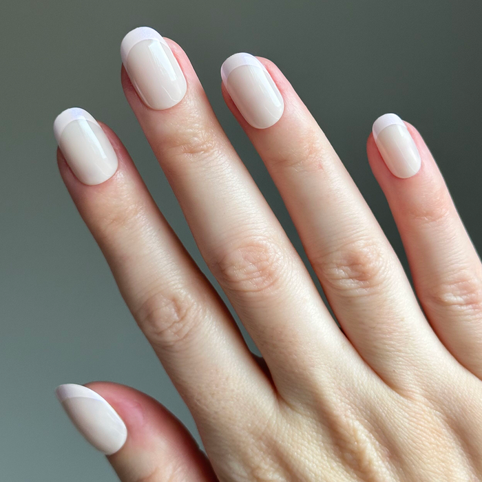 Glazed French | Short | Round - Tab Press-On nails with subtle shimmering chrome French tips on natural short round nails