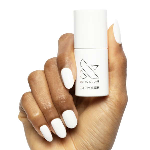 HD - Gel bottle held by hand with smooth, glossy white gel polish on medium-length natural nails for an at-home mani
