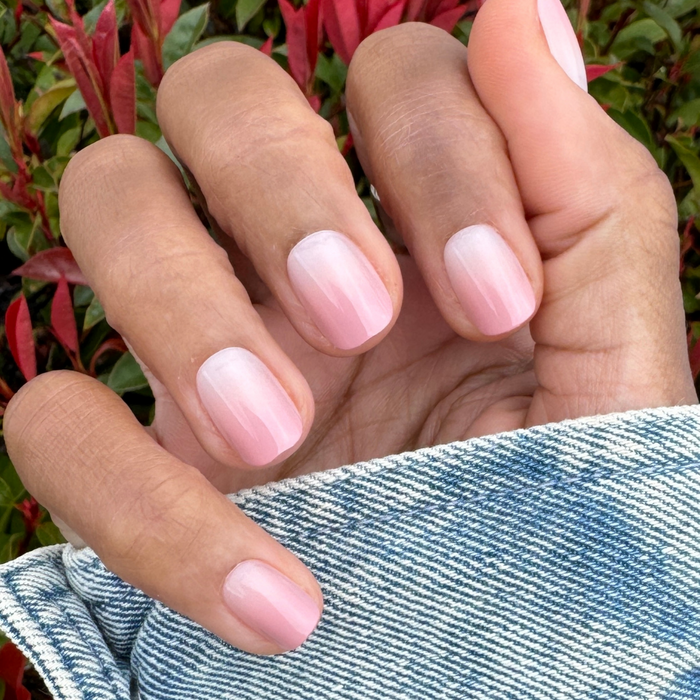 HZ Syrup Gradient - Press-On | Extra Short | Squoval showing extra short squoval false nails with rosey beige gradient manicure on hand outdoors