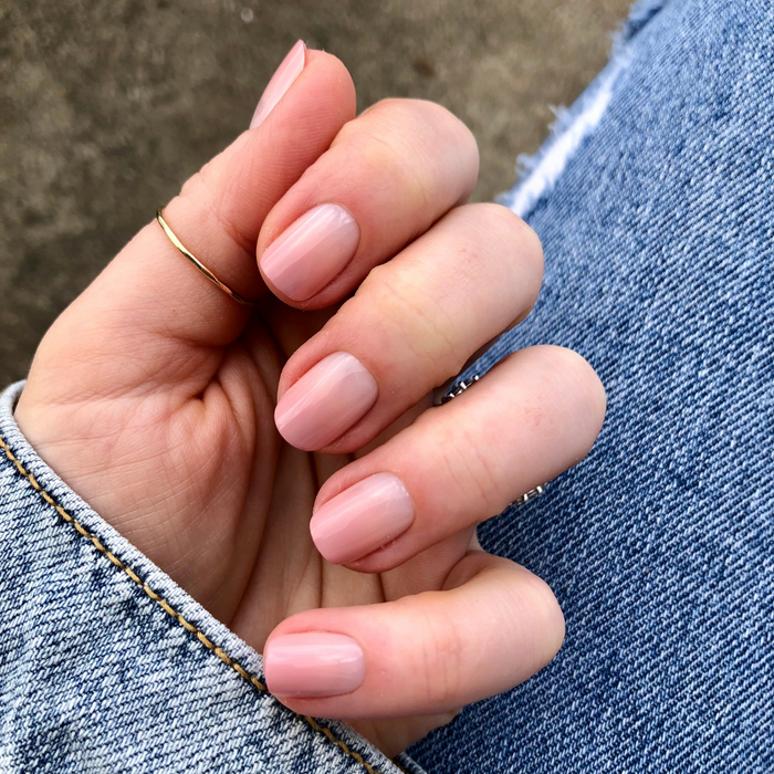 HZ Syrup Gradient - Press-On | Extra Short | Squoval showing hand with extra short squoval nails in rosey-beige gradient mani on denim background