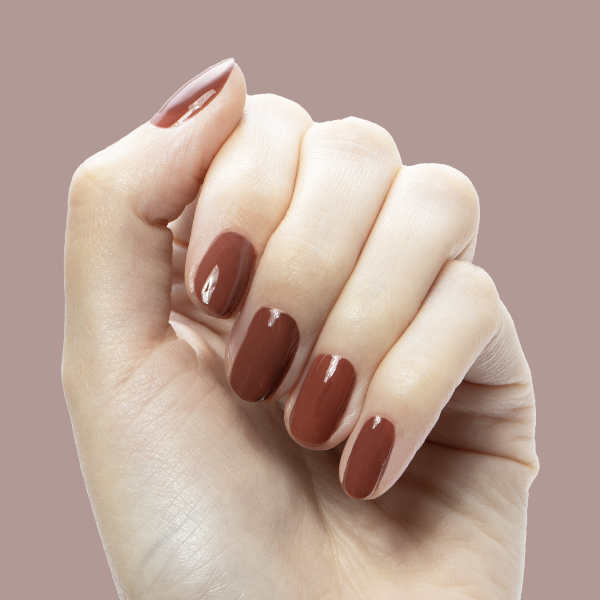JJ - Gel on natural nails in a warm cinnamon brown shade for a cozy, long-lasting manicure by Olive and June