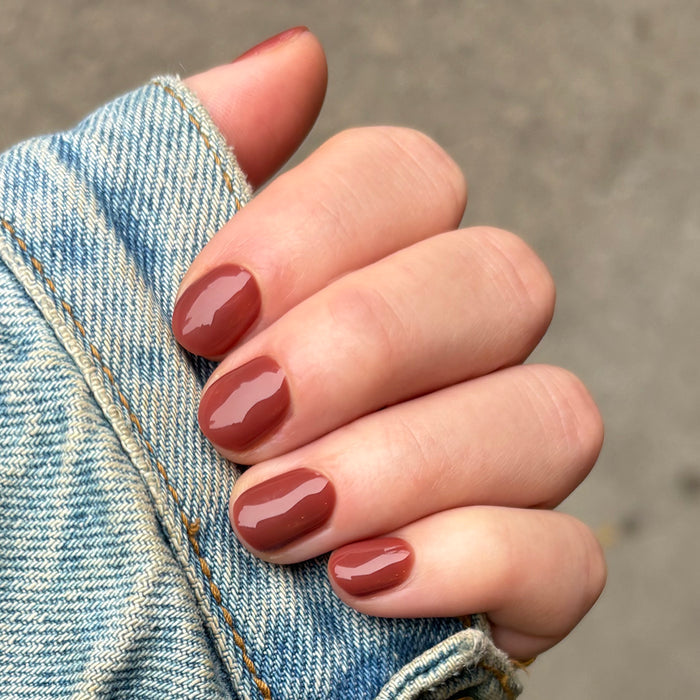 JJ - Gel polished on natural nails in a smooth cinnamon brown shade for a cozy, long-lasting manicure by Olive and June