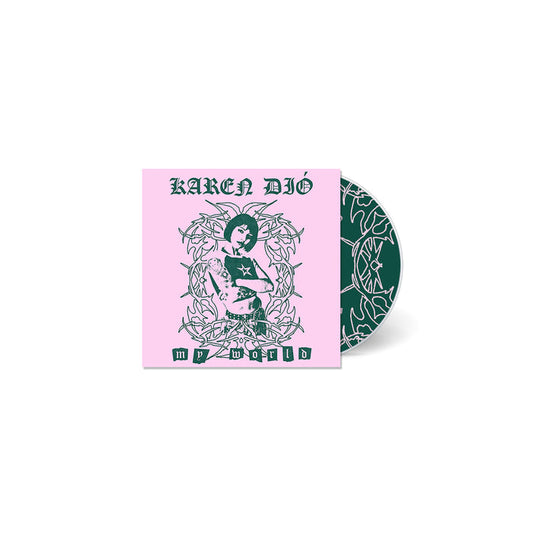 A CD case from Karen Dió with a pink cover showing an illustrated person among ornate designs. The cover says KAREN DIÓ and MY WORLD. The partially visible CD has a matching dark green pattern—funny, unique, and stylish.