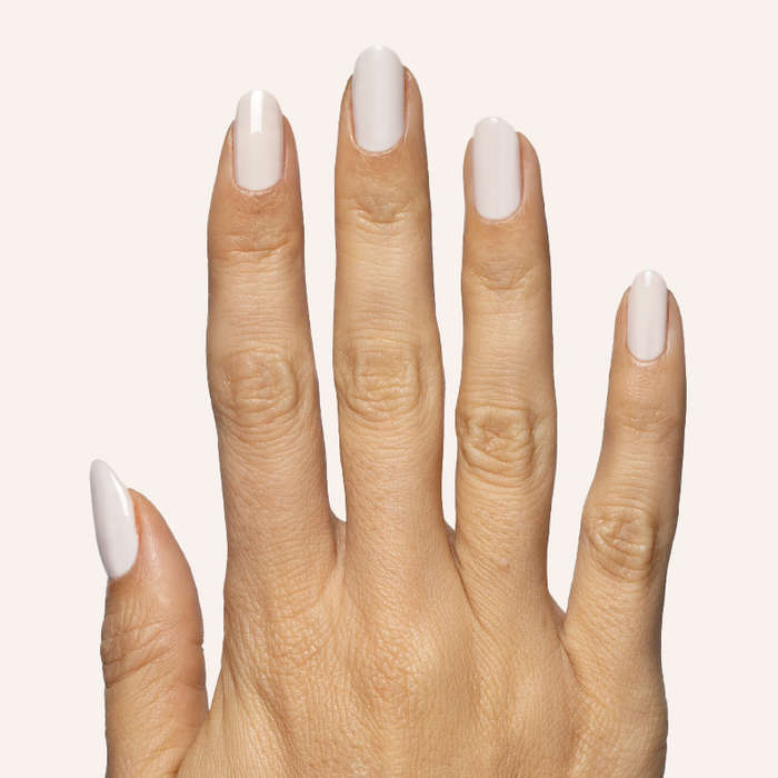 Hand with almond-shaped nails polished in subtle pinky grey shade using LHG - Gel for a neutral mani look