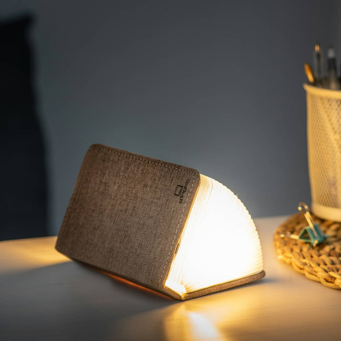 Gingko Design linen fabric smart book light lamp with adjustable brightness, featuring a sleek, modern design for reading or desk use.