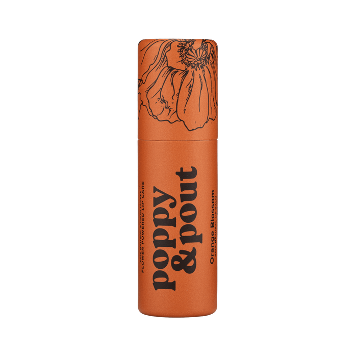 Orange lip balm tube with decorative floral top and bold typography label