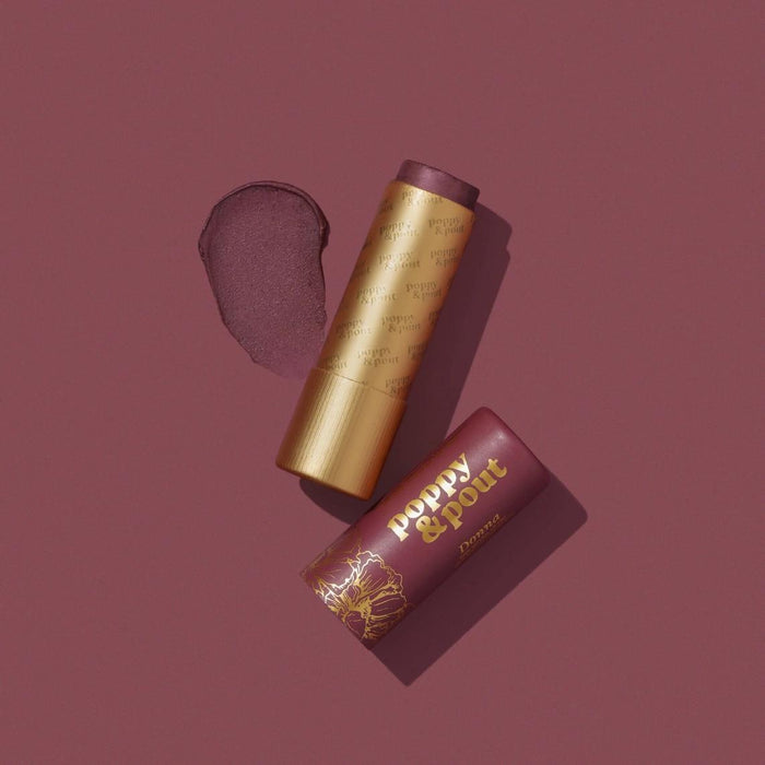 Lip tint duo with gold tube and brown-purple cap, plus lip tint package.