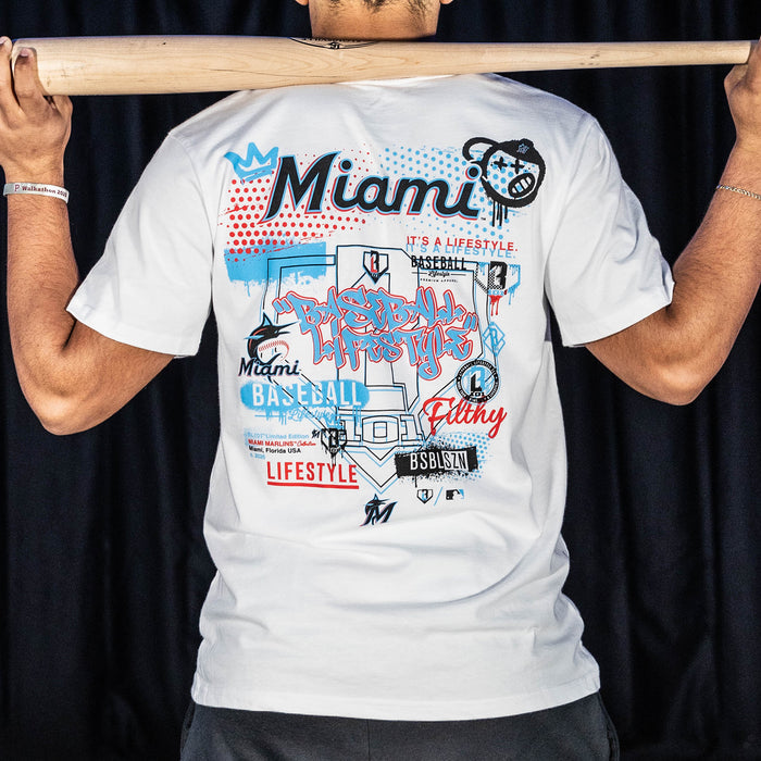 Adult model wearing white graphic tee with "Miami Marlins Drip" design