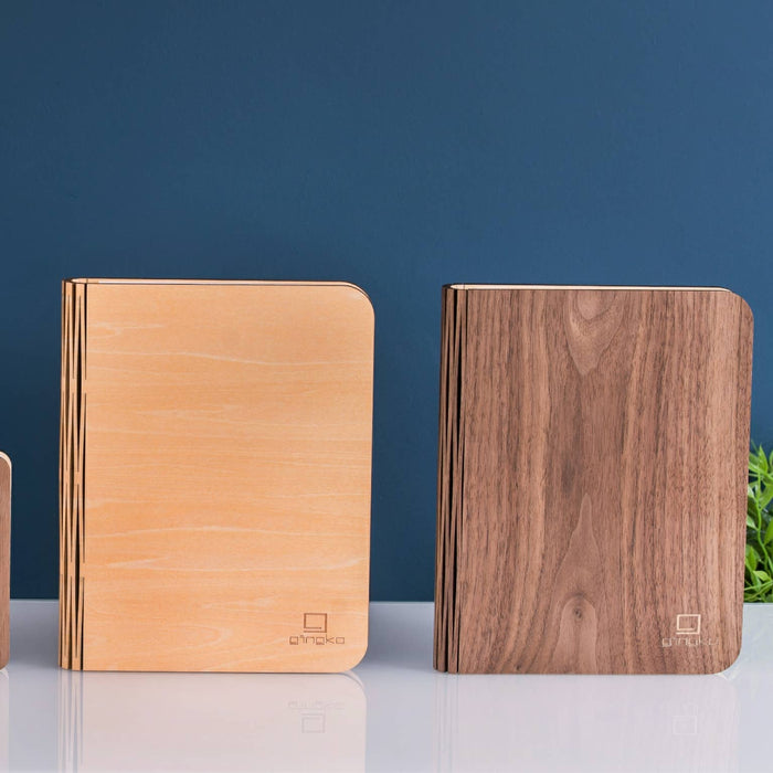 Natural wood smart book light by Gingko Design, featuring a sleek lamp with a wooden finish and adjustable reading light.