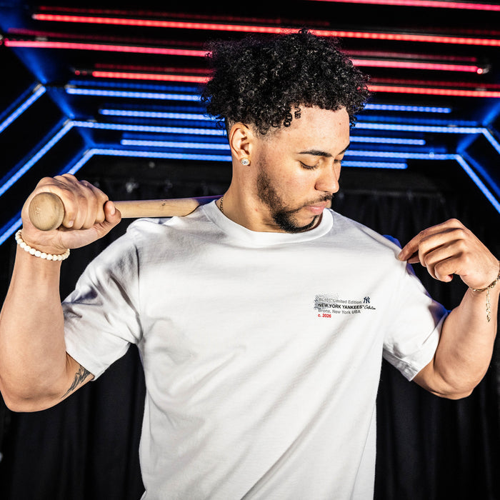 Adult model wearing white graphic tee with "New York Yankees Drip" design