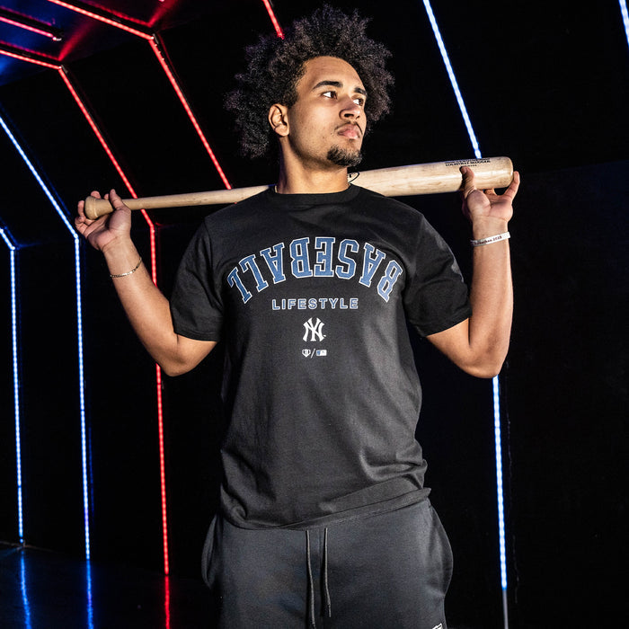 Adult model wearing black graphic tee with "New York Yankees Upside Down" design