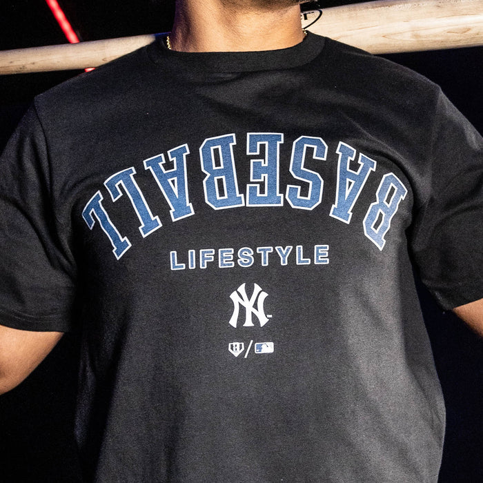 Adult model wearing black graphic tee with "New York Yankees Upside Down" design