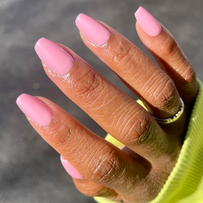 O&J Pink - Press-On | Medium | Coffin nails in soft pink shade displayed on hand with natural sunlight reflection