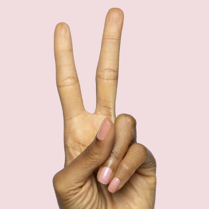 Hand showing peace sign with nails in sheer bubble gum pink-blue iridescent using Olive Y’all - Gel polish